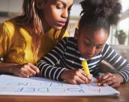 Mother and daughter writing Mother and daughter writing