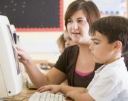 Teacher helping child in the classroom Teacher helping child in the classroom