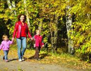 Mum walking with children in woods