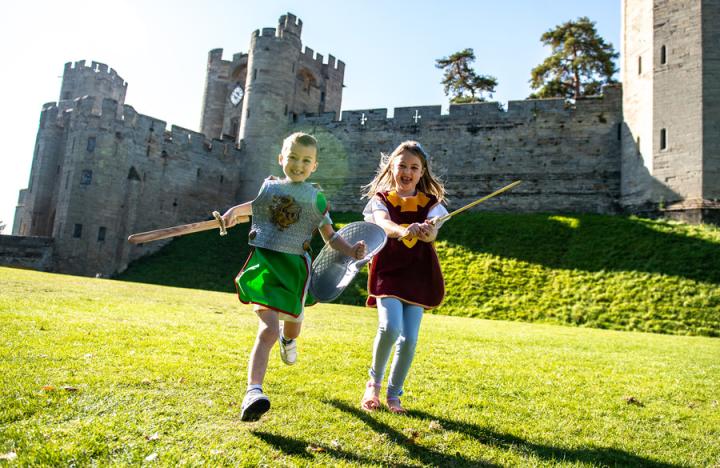 Children playing by castle ©️Warwick Castle