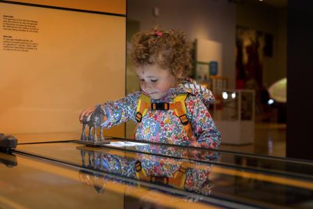 Young child playing games and learning at the Museum of Cardiff