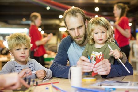 Family taking part in educational activities at We the Curious museum 