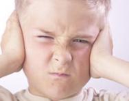 Angry child with hands over ears Angry child with hands over ears