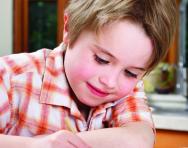 KS1 boy doing spelling homework KS1 boy doing spelling homework