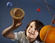 Boy looking at solar system model Boy looking at solar system model