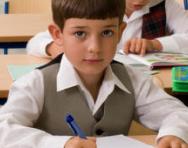 Little boy at his desk looking confused Little boy at his desk looking confused