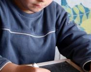 Boy writing maths on blackboard Boy writing maths on blackboard
