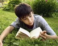 Boy reading in the park Boy reading in the park
