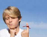Boy with string tied on finger Boy with string tied on finger