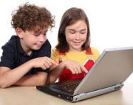 Brother and sister playing on laptop Brother and sister playing on laptop
