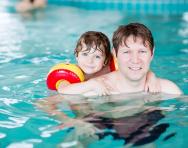Child and parent in swimming pool Child and parent in swimming pool