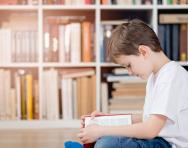 Child reading in a library Child reading in a library