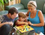 Family playing a board game Family playing a board game