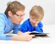 Father and son reading together Father and son reading together