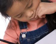 Child writing in pencil Child writing in pencil