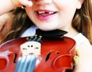 Girl laughing with violin Girl laughing with violin