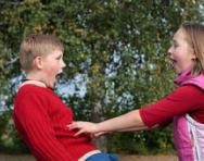 Girl pushing boy playfully Girl pushing boy playfully