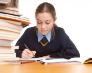 Girl writing at desk Girl writing at desk