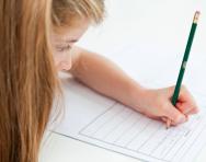 Girl writing in exercise book Girl writing in exercise book