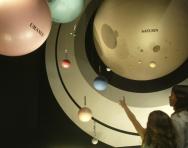 Children visiting a space museum exhibit Children visiting a space museum exhibit