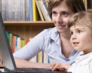 Mum and child working at computer together Mum and child working at computer together