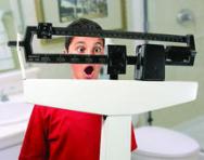 Shocked boy on weighing scales Shocked boy on weighing scales