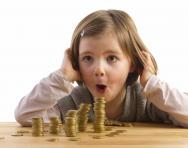 girl looking at pile of coins girl looking at pile of coins