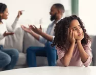 Co-parenting a primary school child Child looking sad as parents argue