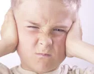 Angry child with hands over ears
