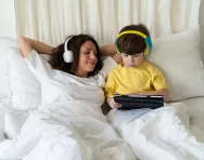 Bigstock mother and son listening in bed Bigstock mother and son listening in bed