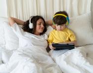 Bigstock mother and son listening in bed