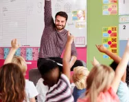 Children raising their hand in Religion and Worldviews class Children raising their hand in class