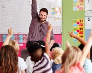 Children raising their hand in class 