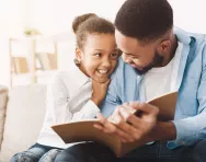 Child reading with father Child reading with father
