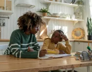 Mother helping child with homework Mother helping child with homework BigStock image
