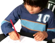 Boy writing at desk Boy writing at desk