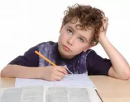 Boy looking confused doing homework Boy looking confused doing homework