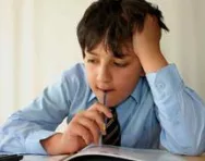 Boy puzzling over book Boy puzzling over book