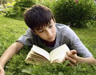 Boy reading in the park