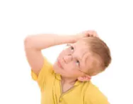 Boy scratching his head