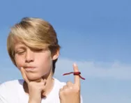 Boy with string tied on finger