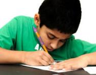 Boy writing at desk