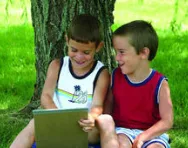 Boys giggling over a book Boys giggling over a book