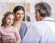 Child and mother speaking to doctor