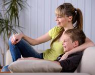 Child and parent watching TV - best educational TV shows for KS2