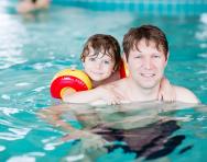 Child and parent in swimming pool