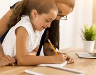 Child and parent writing