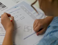 Child completing maths paper