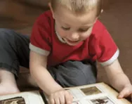 Child looking at photo album