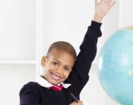 Child raising hand in classroom
